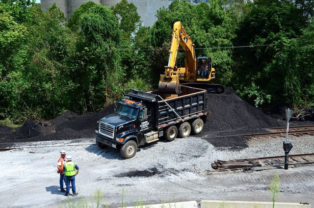 Coal is placed carefully to avoid creating dust