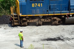Dust flies from crushed stone on the rail